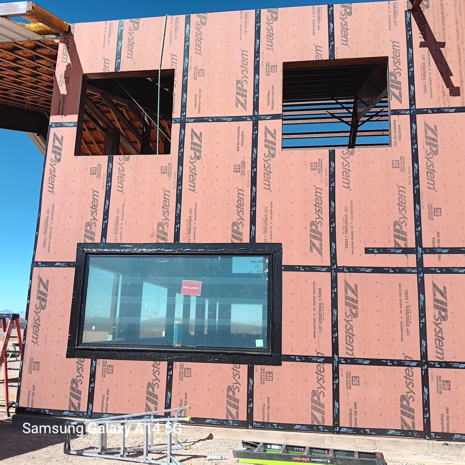 A building under construction with a samsung camera taking a picture