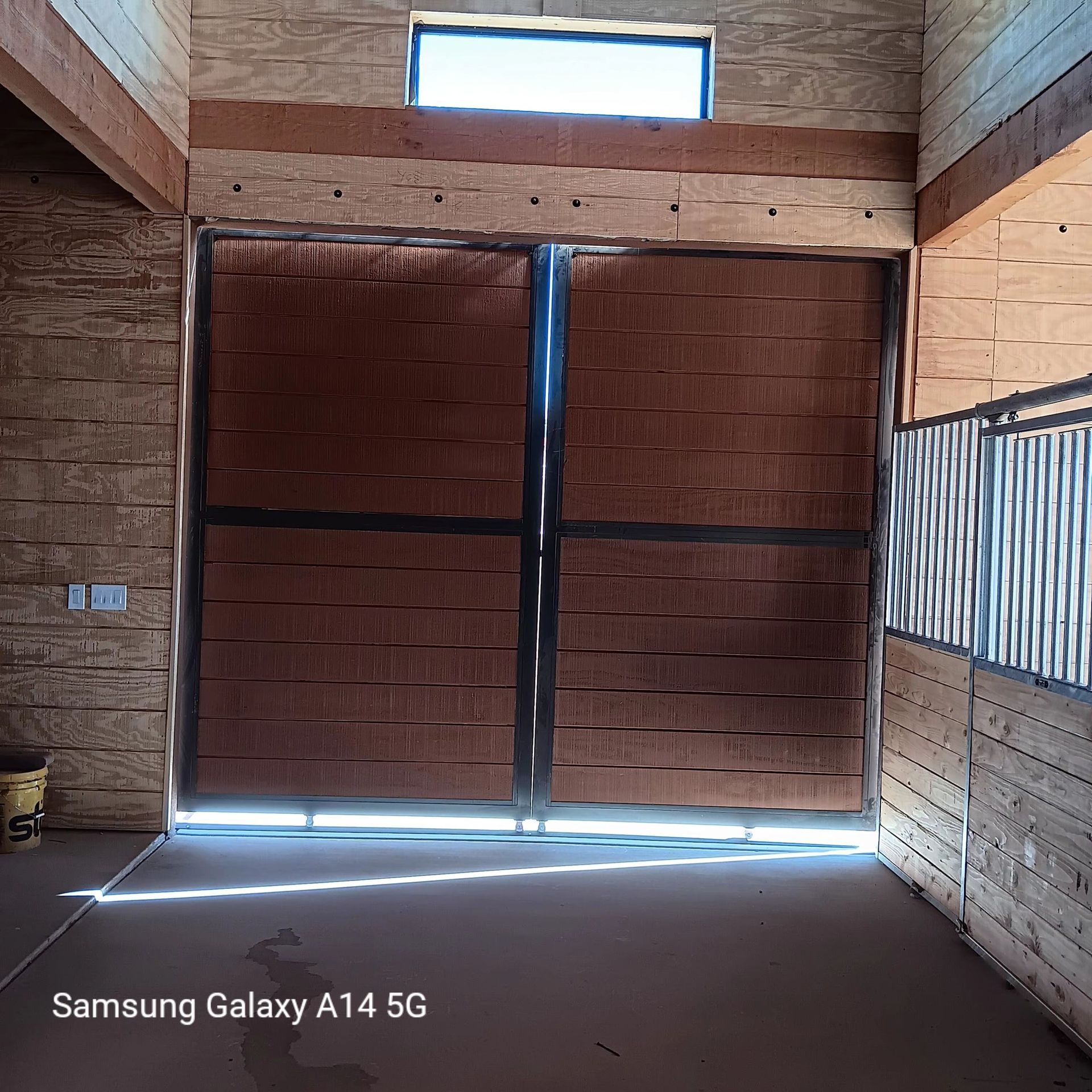 A samsung galaxy a14 5g is being used to take a picture of a barn