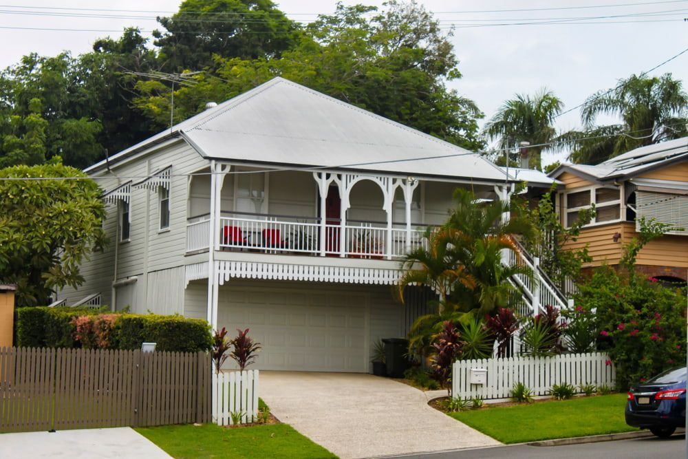 A White House with A Car Parked in Front of It — Rearden Fencing Pty Ltd in Toronto, NSW
