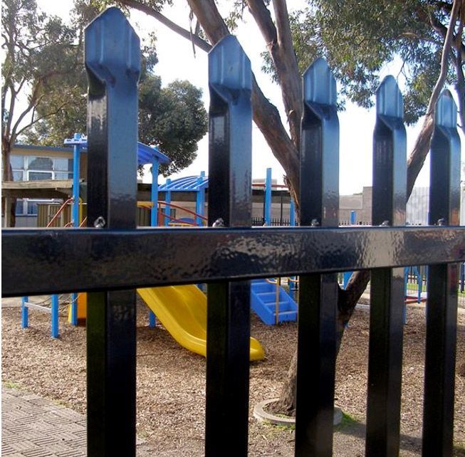 A Black Fence Surrounds a Playground With a Slide and Stairs — Rearden Fencing Pty Ltd in Toronto, NSW