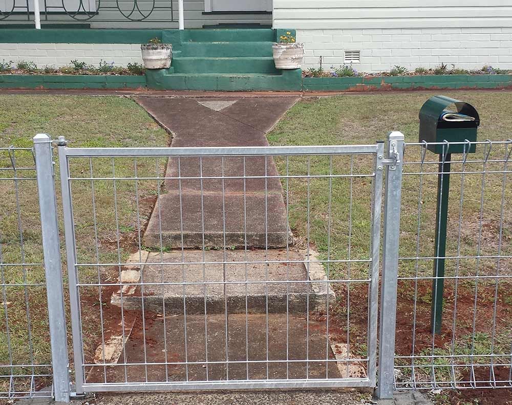 A Fence With a Mailbox in Front of a House — Rearden Fencing Pty Ltd in Toronto, NSW