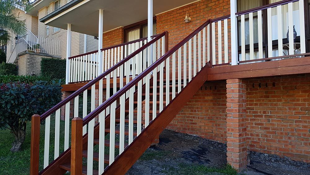 A Wooden Staircase Leading Up to a Porch of a Brick House — Rearden Fencing Pty Ltd in Toronto, NSW
