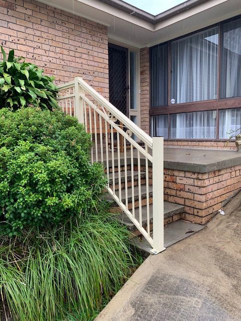 A Brick House With Stairs Leading Up to the Front Door — Rearden Fencing Pty Ltd in Toronto, NSW