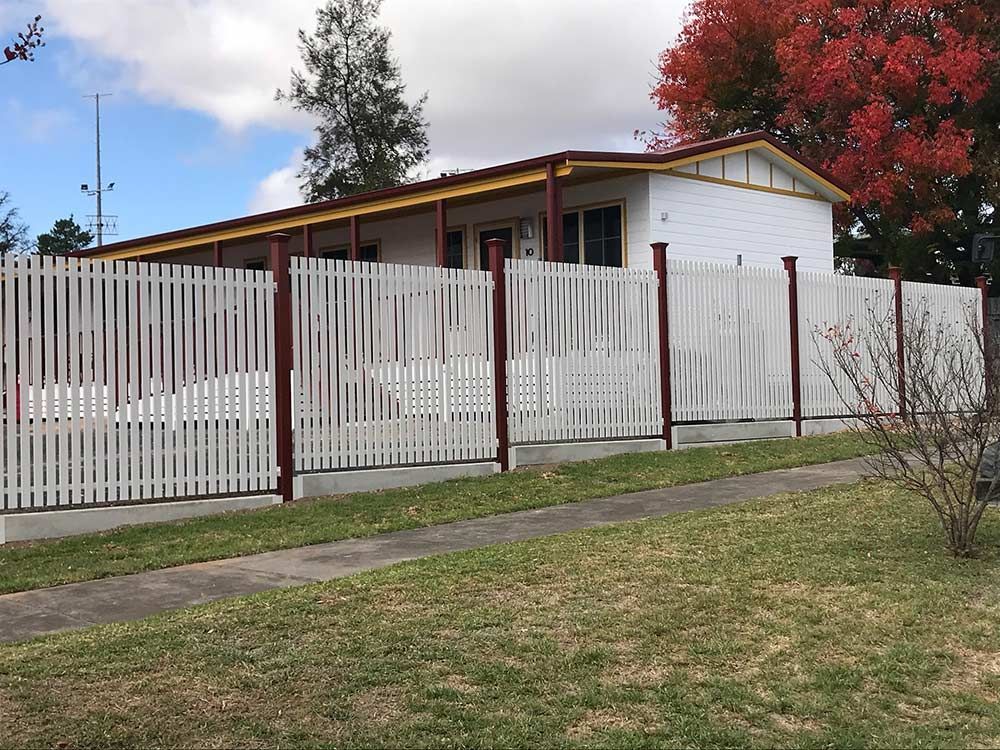 A House With a White Picket Fence Around It — Rearden Fencing Pty Ltd in Toronto, NSW