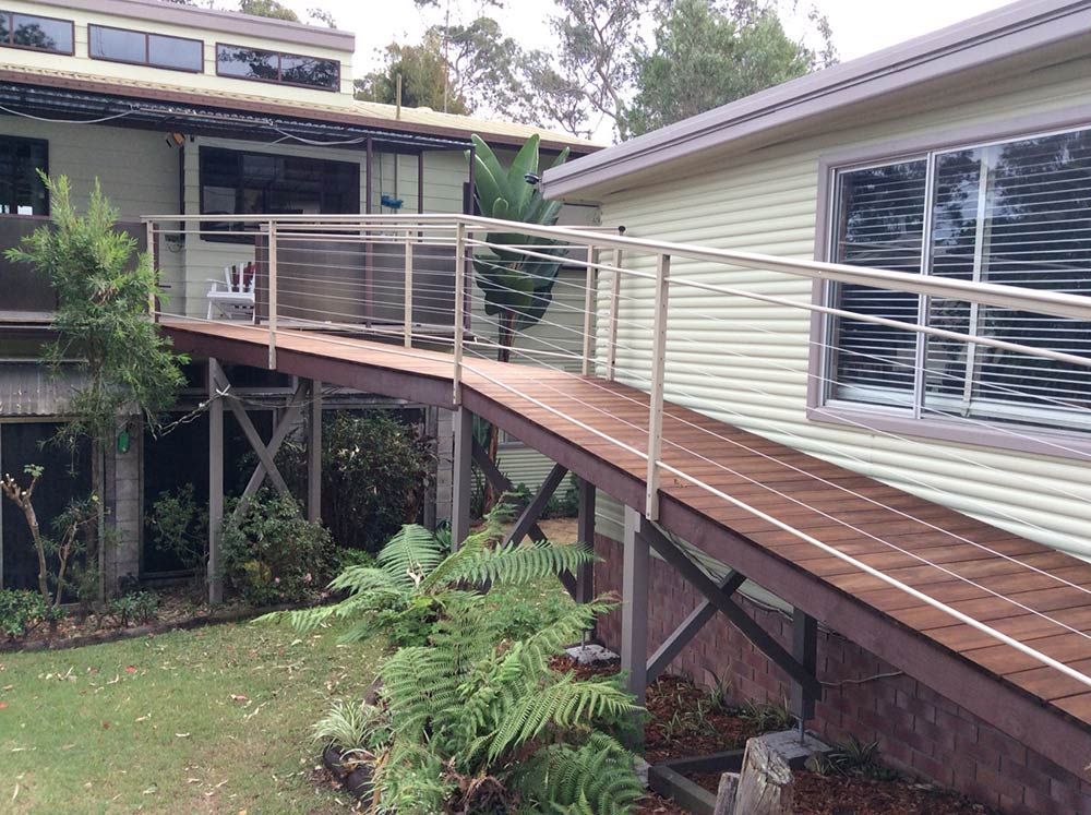 A House With a Wooden Ramp Leading Up to It — Rearden Fencing Pty Ltd in Toronto, NSW