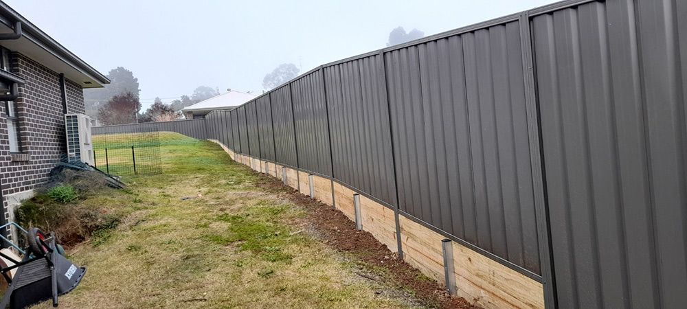There is a Fence in the Backyard of a House — Rearden Fencing Pty Ltd in Toronto, NSW