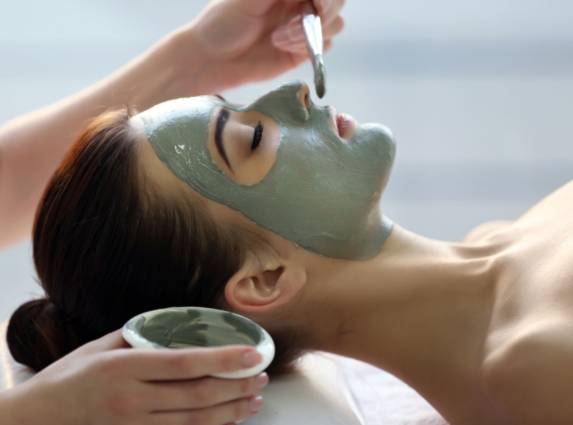 a woman is getting a facial treatment at a spa .