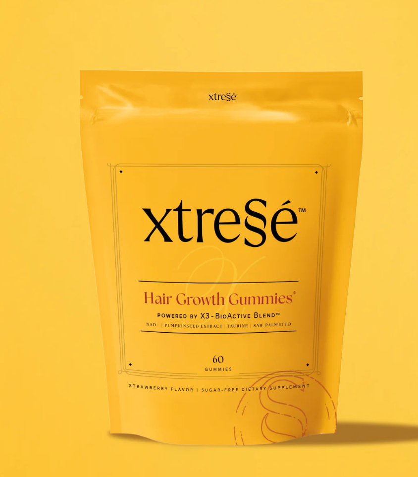 A bag of xtrese hair growth gummies on a yellow background