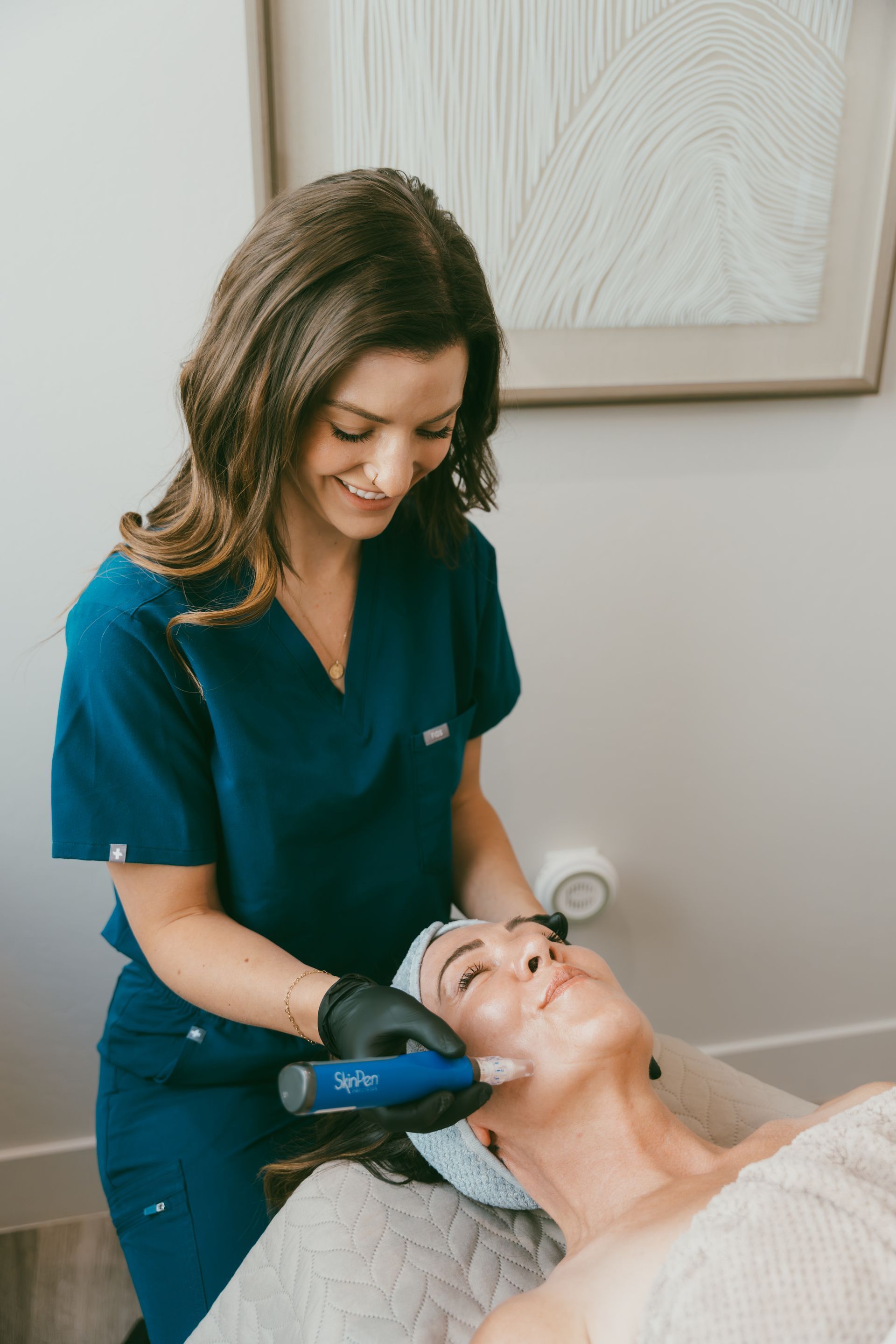 a woman is getting a cosmetic treatment on her forehead .