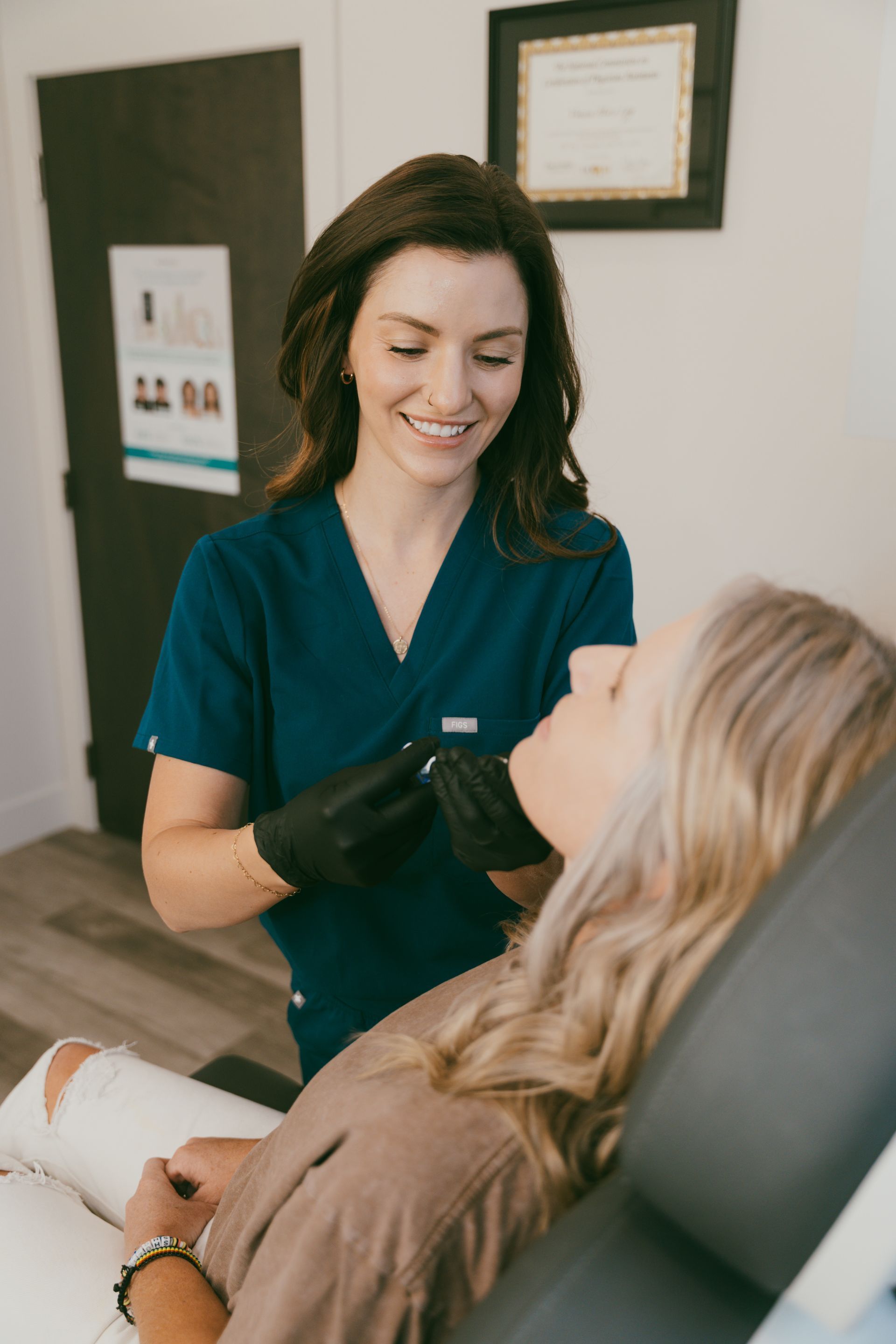 a woman is getting a botox injection in her lips .