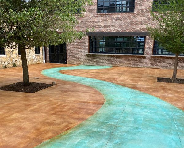 A brick building with a green walkway leading to it.