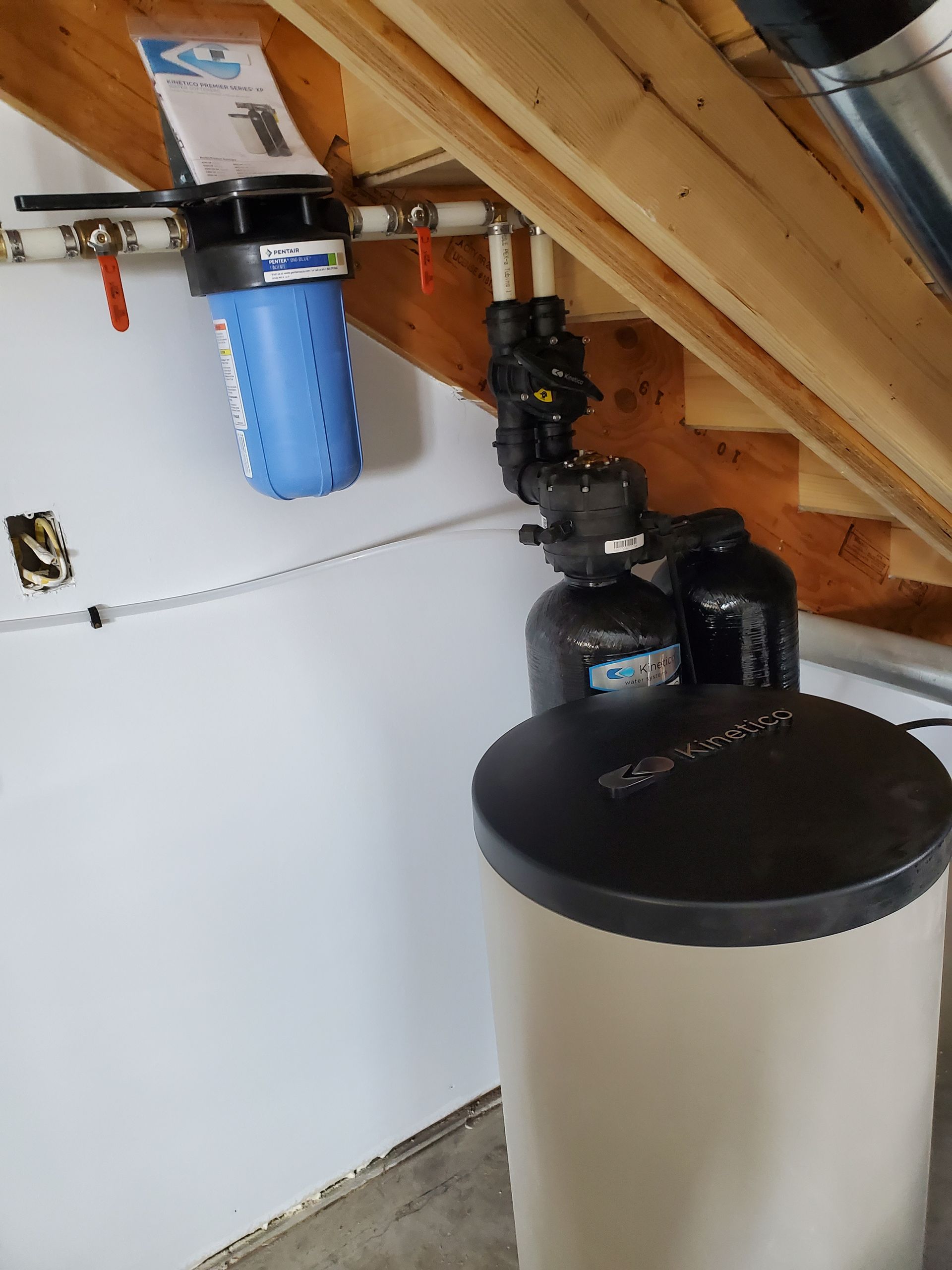 Water filtration and softening system installed in a residential garage.