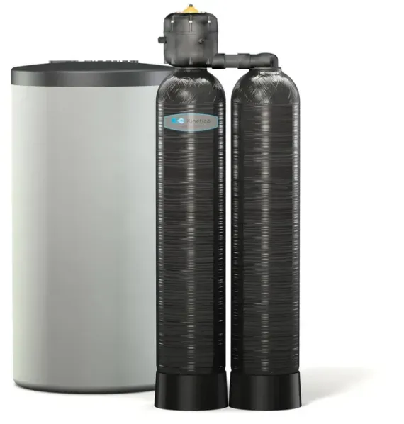 Water filtration system with three cylindrical tanks, connected by pipes, next to a larger white tank.