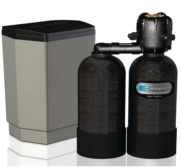 Water softener system: salt tank (left) and two black tanks connected by pipes.