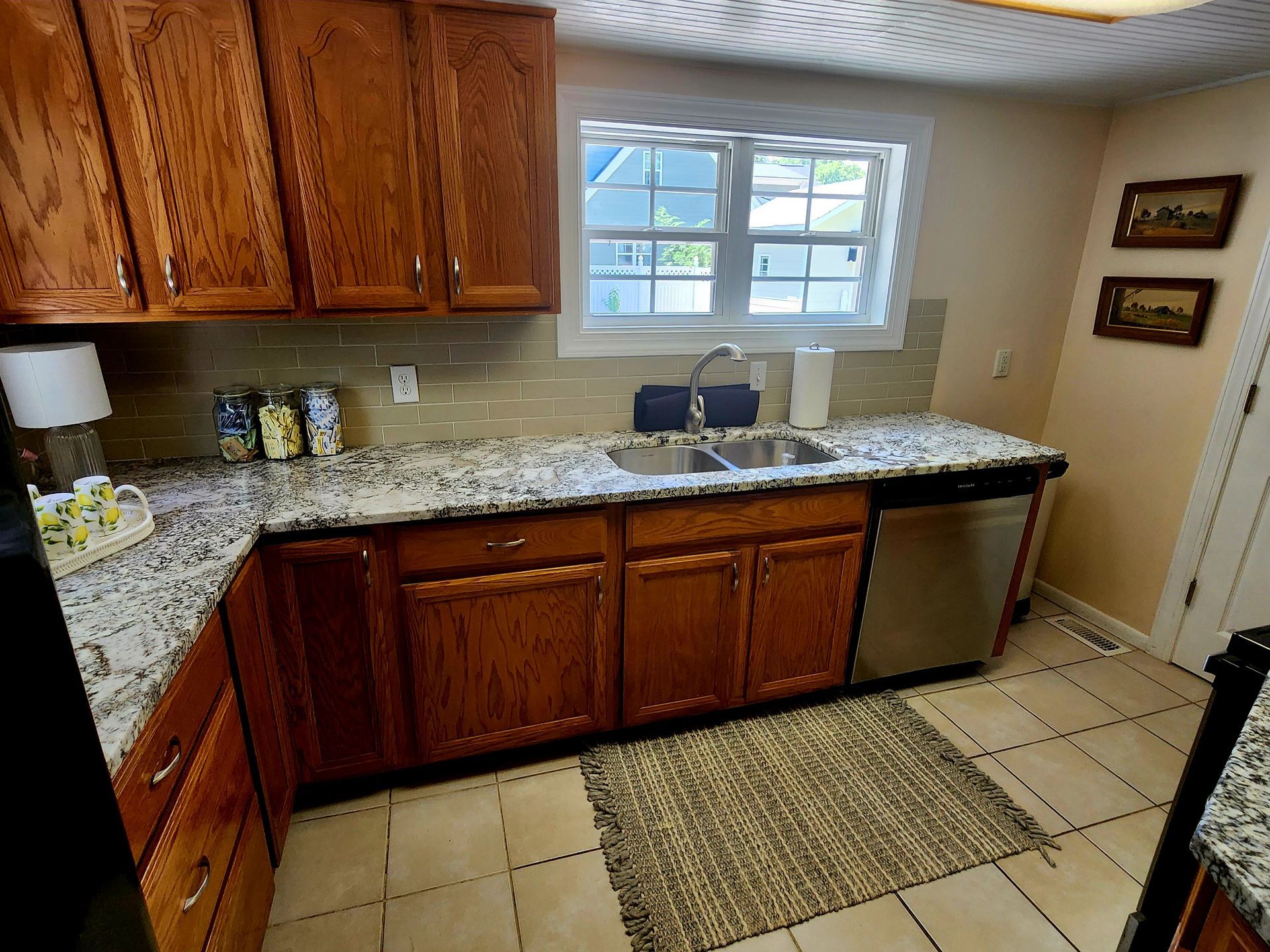 Kitchen with wooden cabinets, granite countertops, and stainless steel appliances.