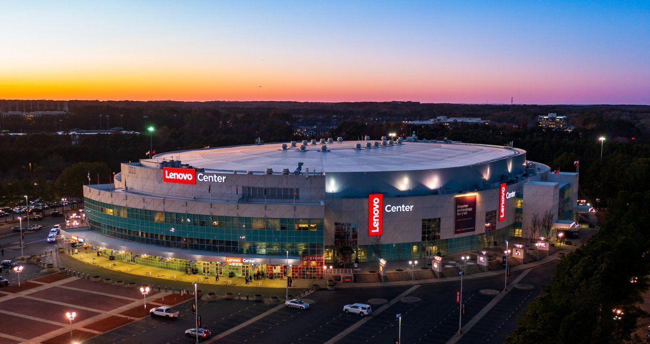Exterior view of a large, circular arena with red