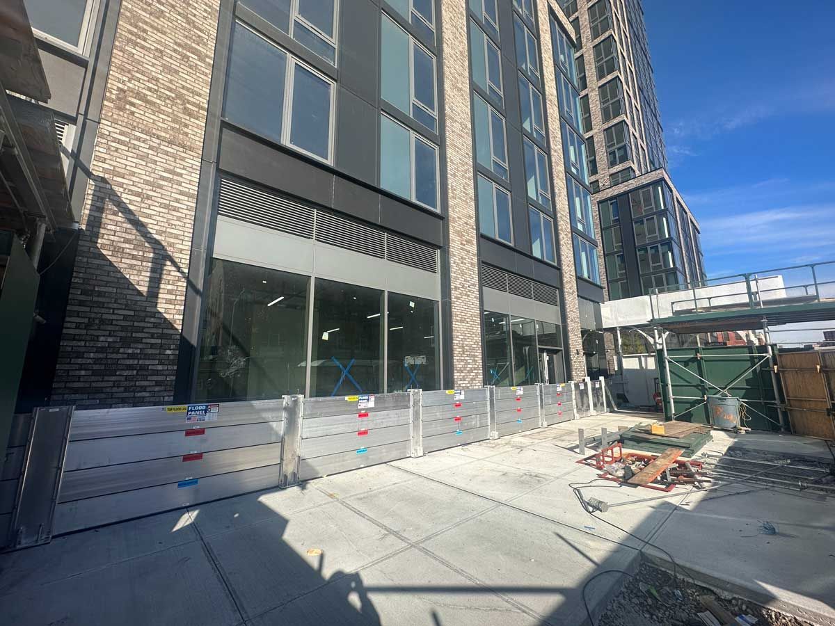 A large building with a lot of windows is under construction.