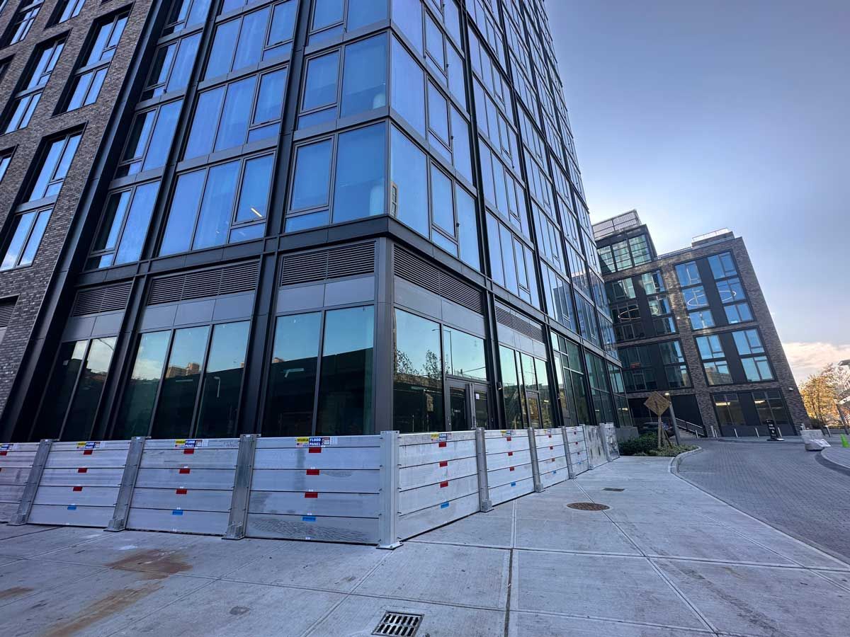 A large building with a lot of windows is under construction.