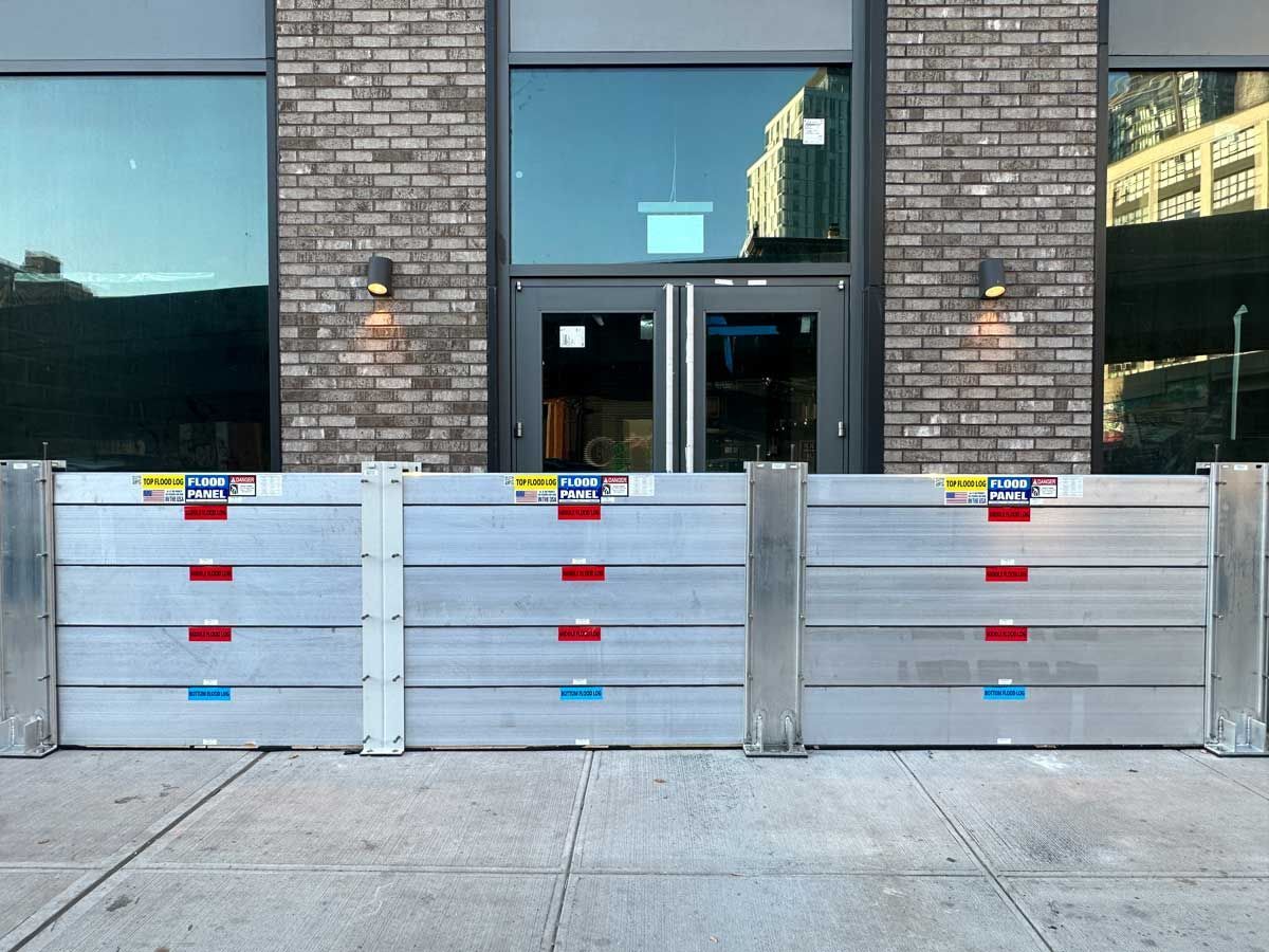 A brick building with a flood barrier in front of it