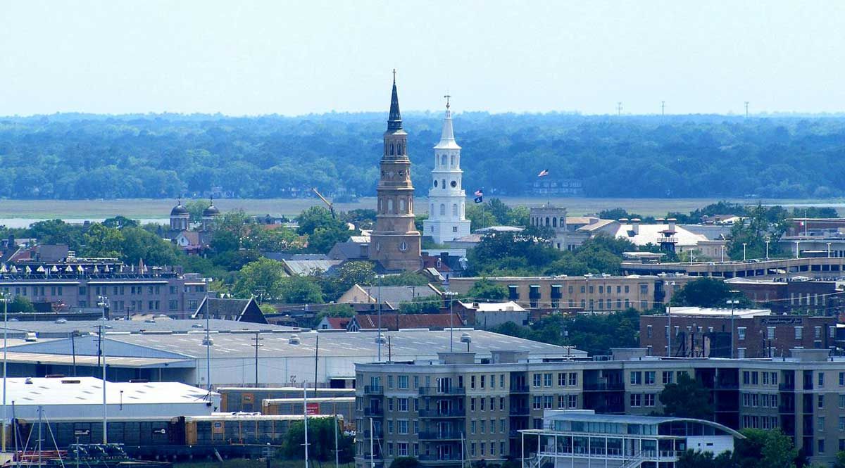 An aerial view of a city with a tower in the distance