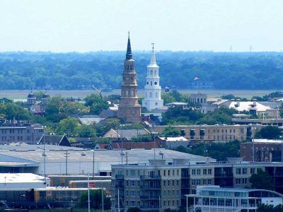 An aerial view of a city with a clock tower in the foreground