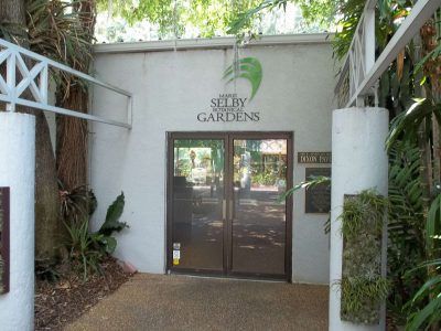 A white building with a sign that says set by gardens