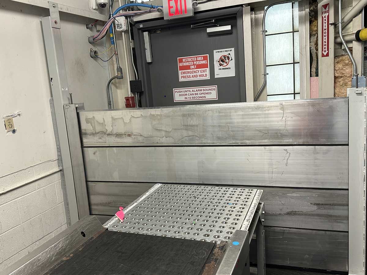 A door with a red exit sign on it is in a room.