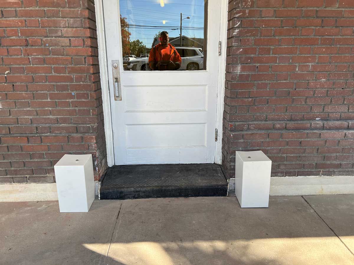 A white door with a brick wall behind it