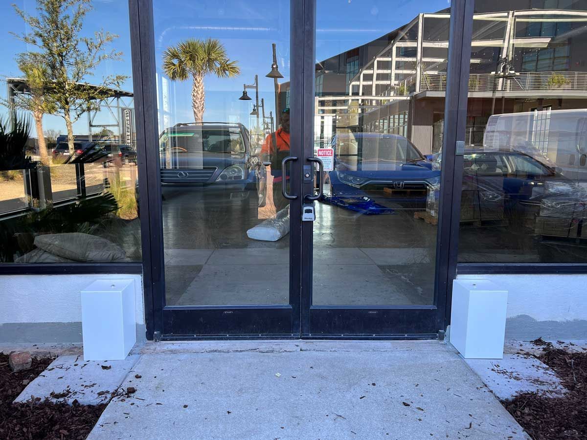A glass door with a reflection of a building in it