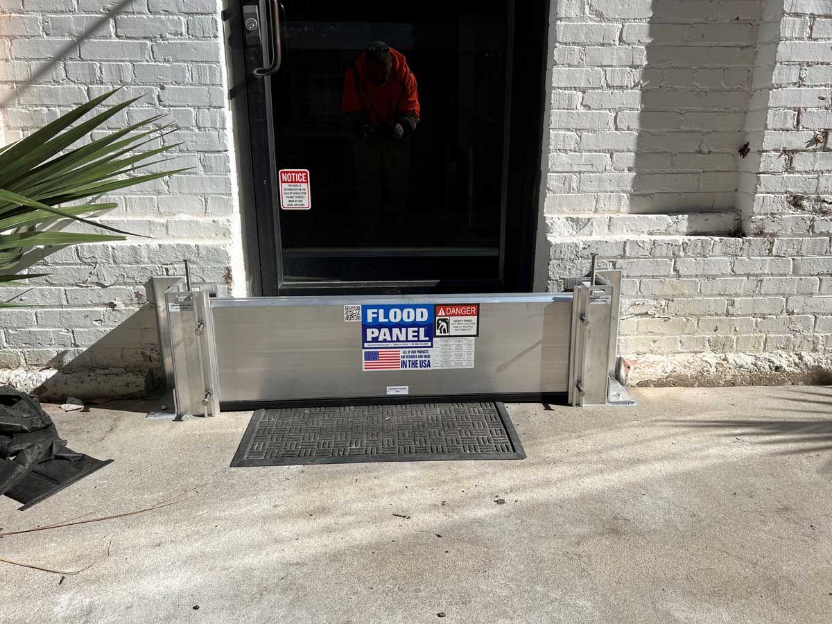 A flood barrier is sitting in front of a brick building
