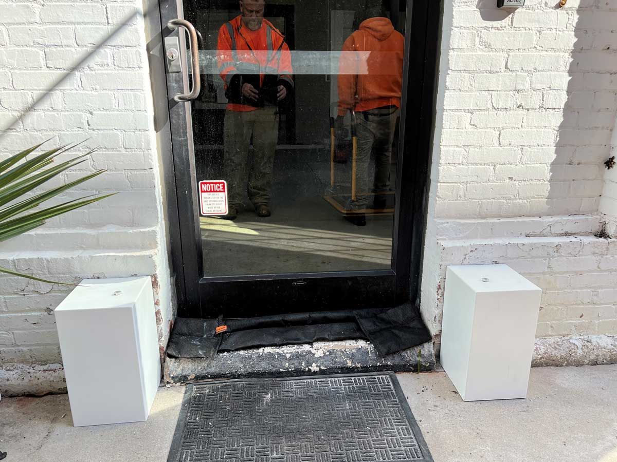 A man is standing in the doorway of a building.