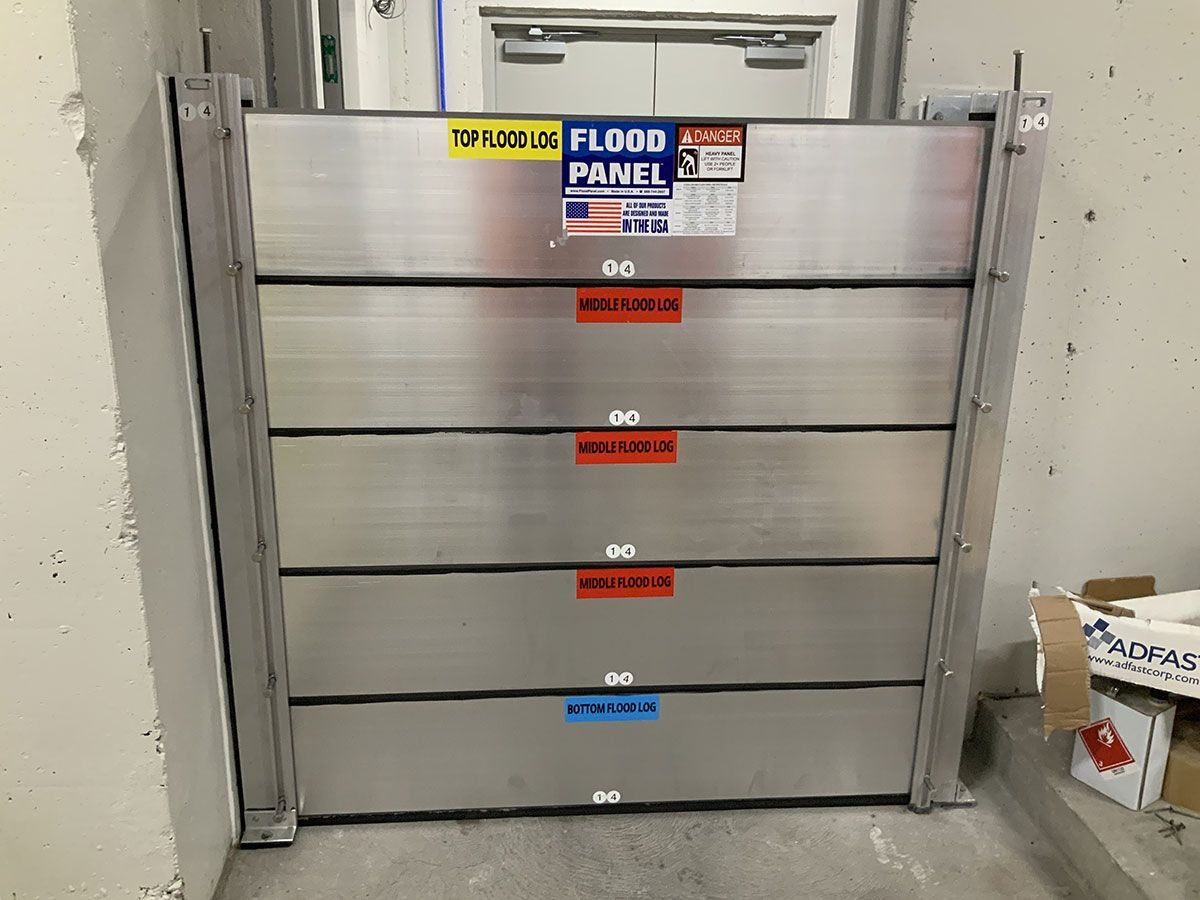 A stainless steel flood panel is sitting in a room.