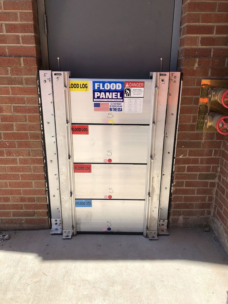 A flood panel is attached to a brick wall