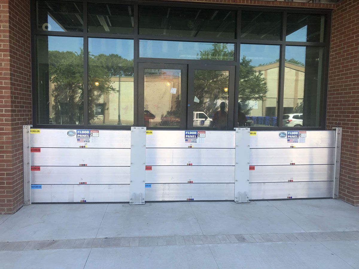 A brick building with flood barriers in front of it