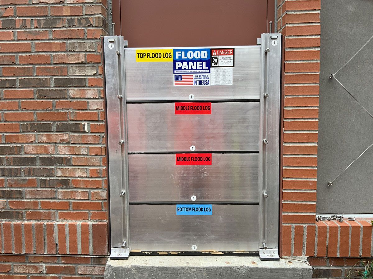 A flood panel is attached to a brick wall