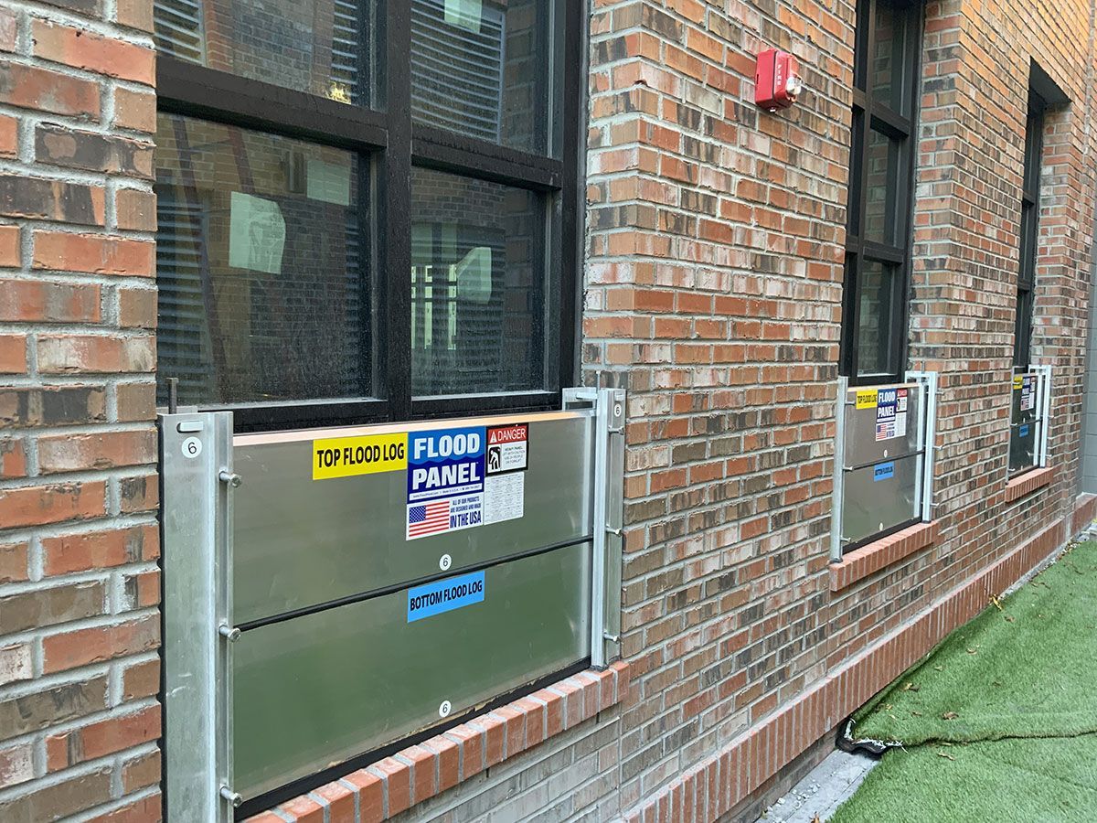 A brick building with a flood barrier on the side of it.