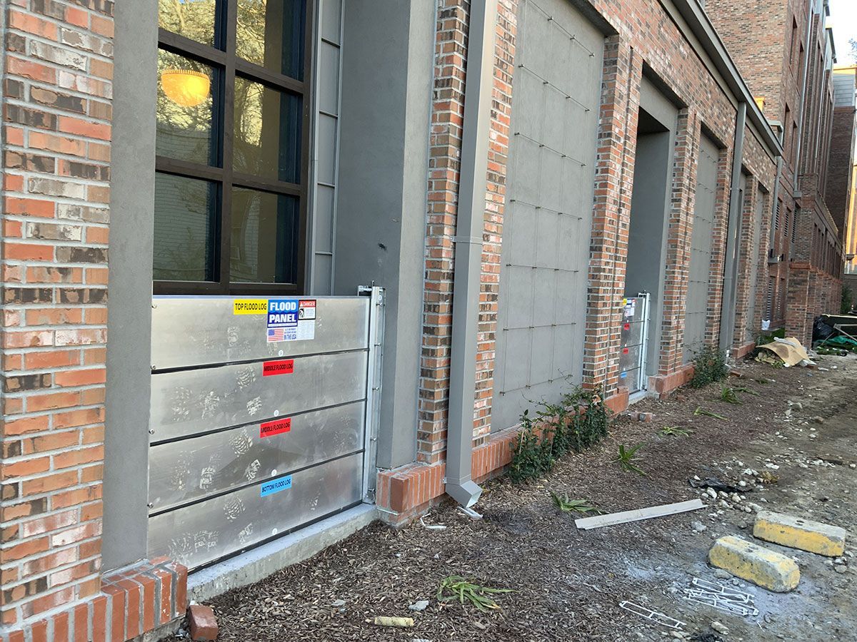A brick building with a flood barrier on the side of it.