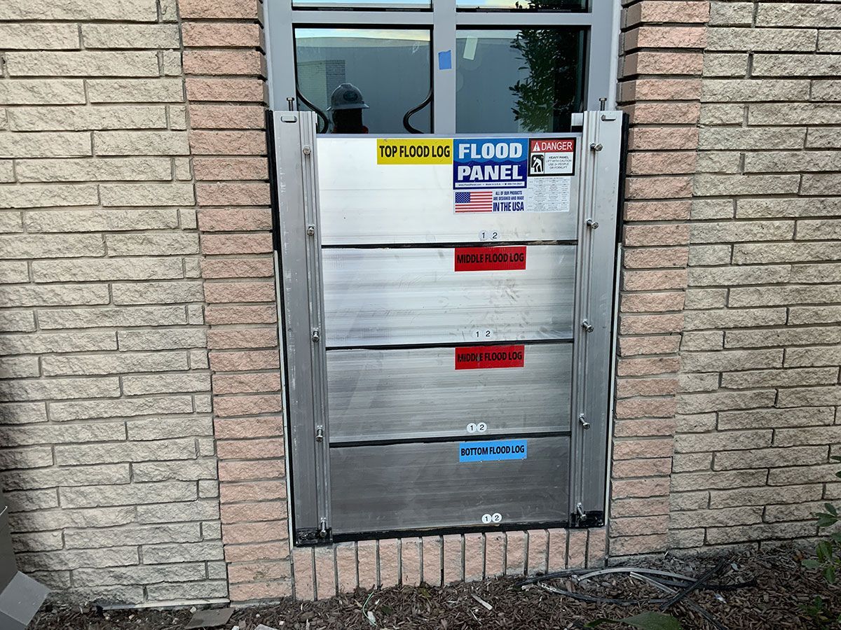 A brick wall with a flood barrier on it
