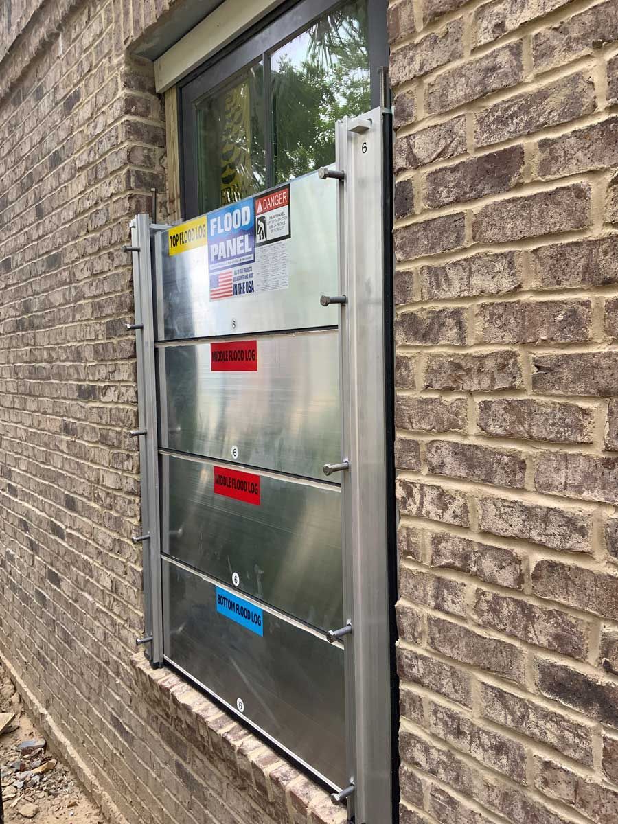 A brick building with a metal barrier on the side of it.