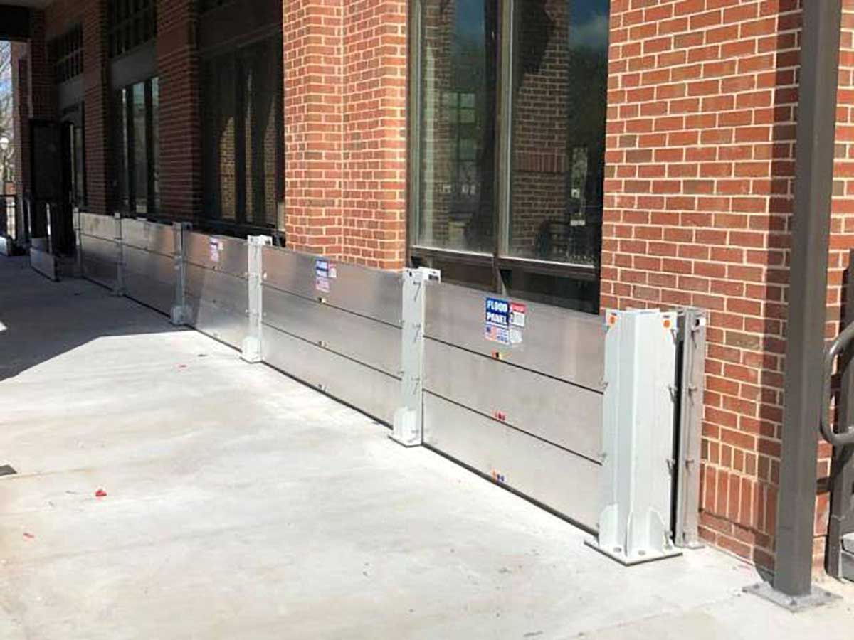 A brick building with a flood barrier on the side of it.