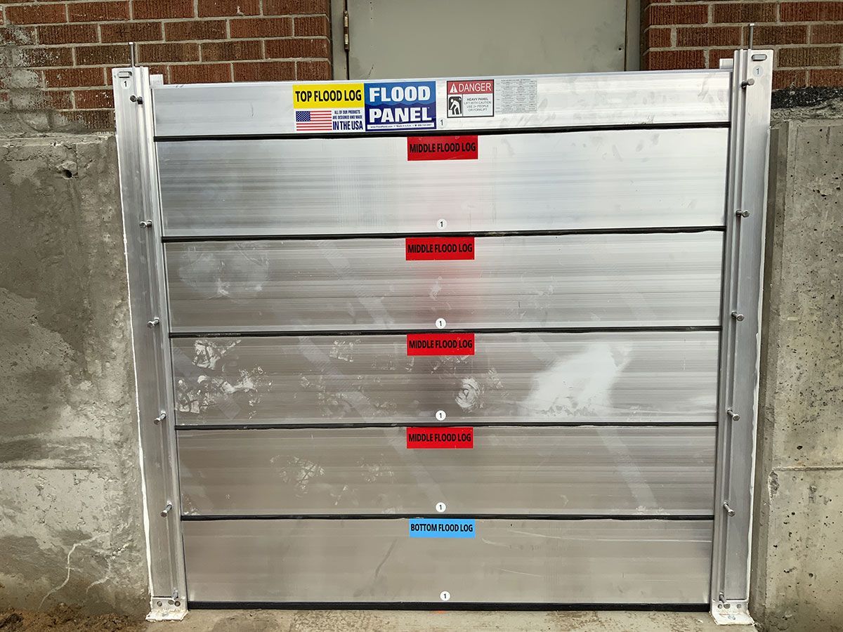 A flood panel is attached to the side of a building