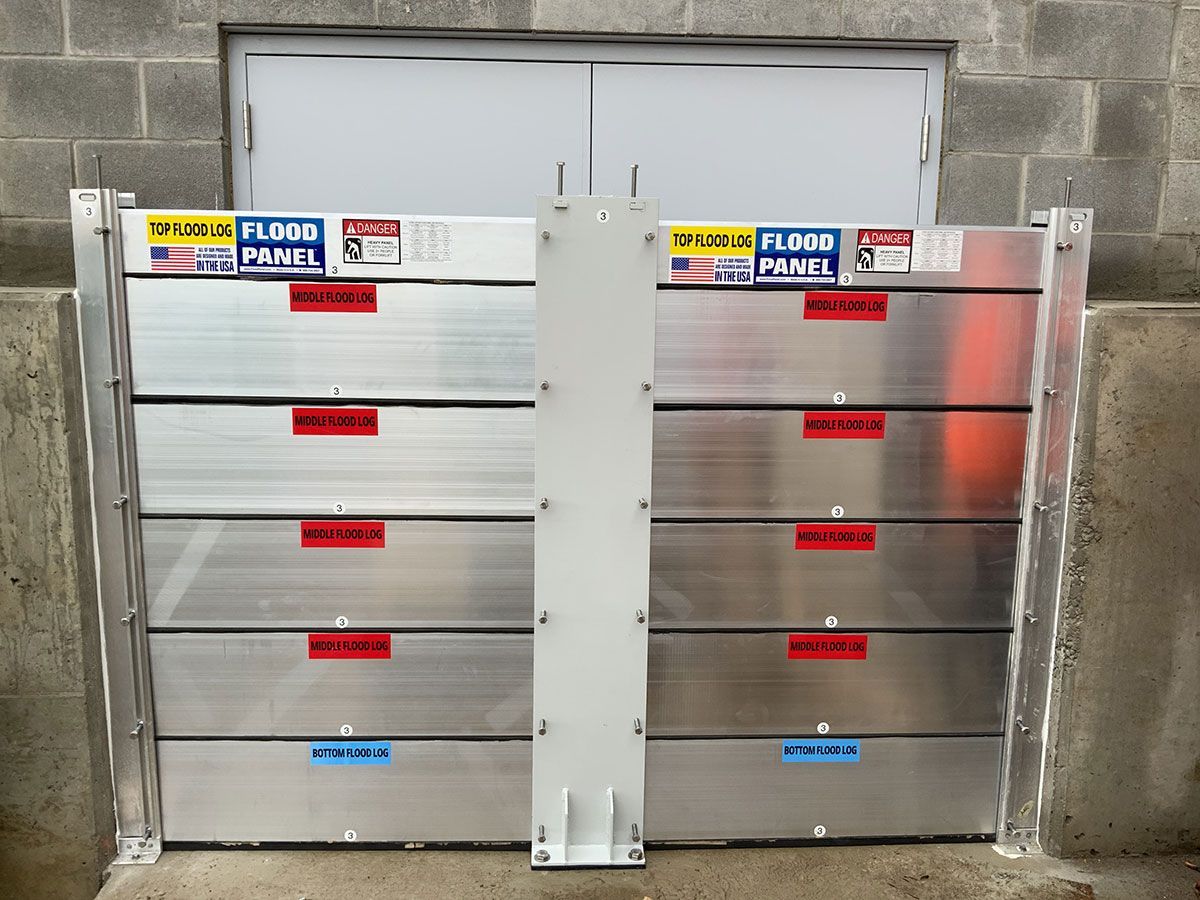 A flood barrier is sitting in front of a brick building