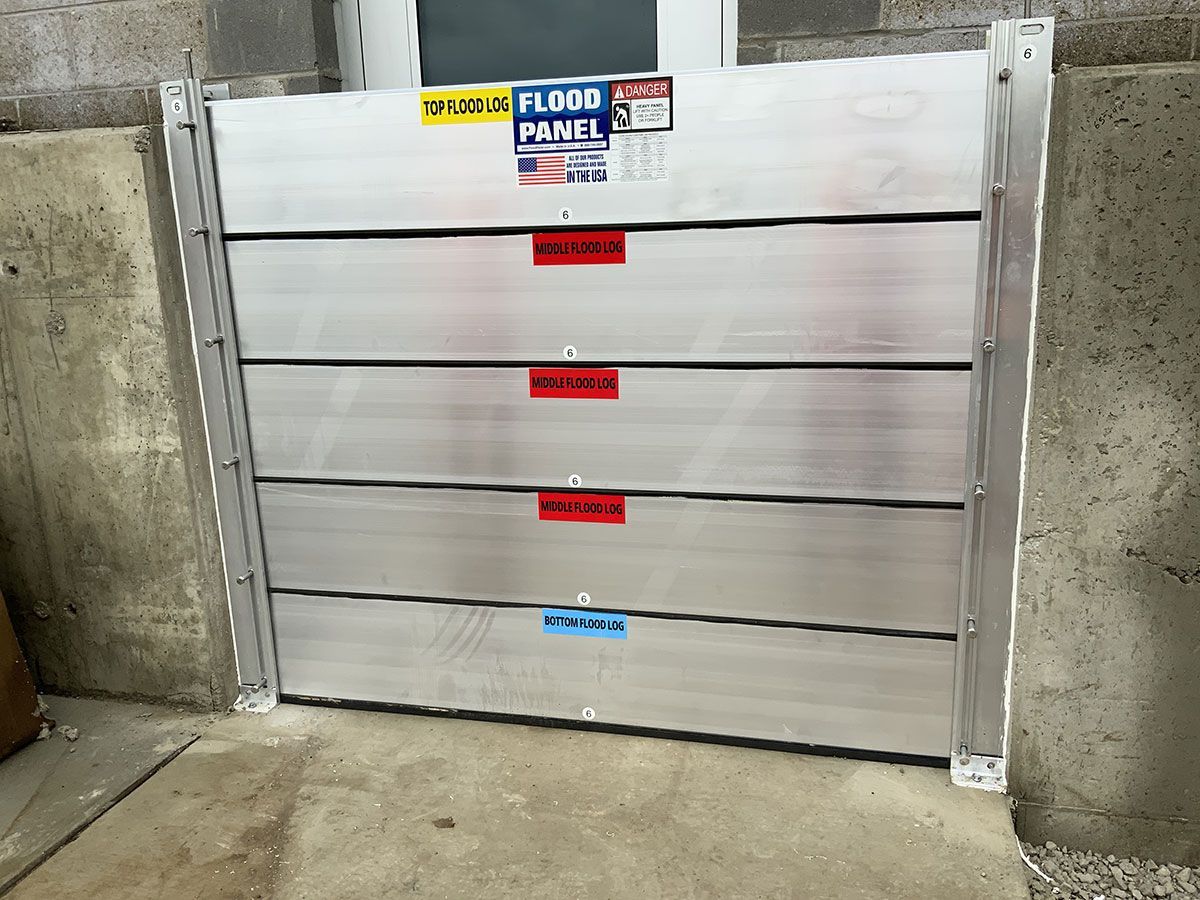 A flood barrier is sitting on the side of a building.