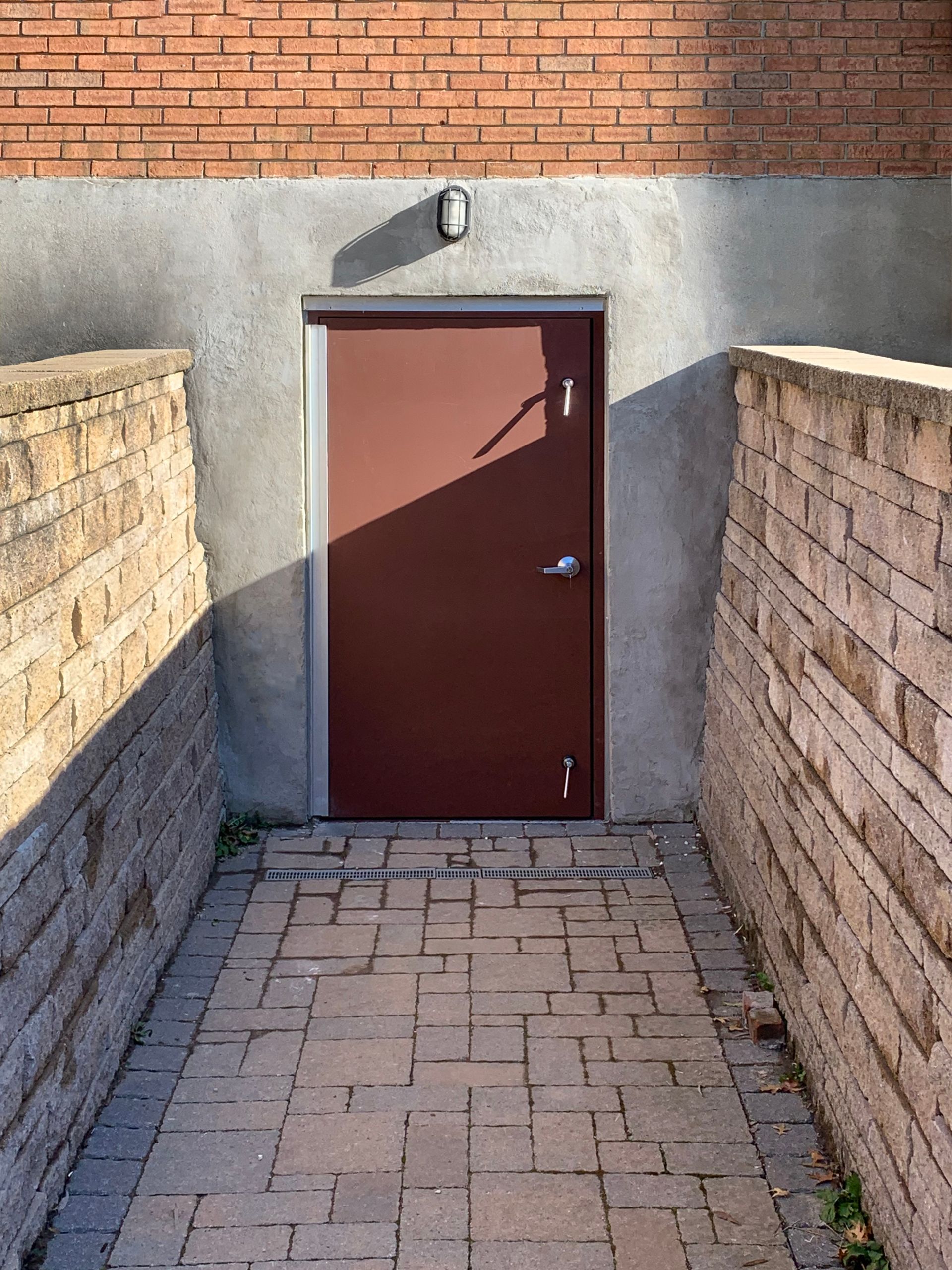 A brick wall with a door in the middle of it