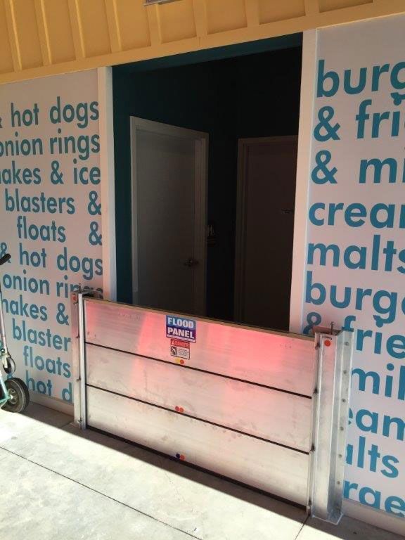 A sign on a wall that says hot dogs on it