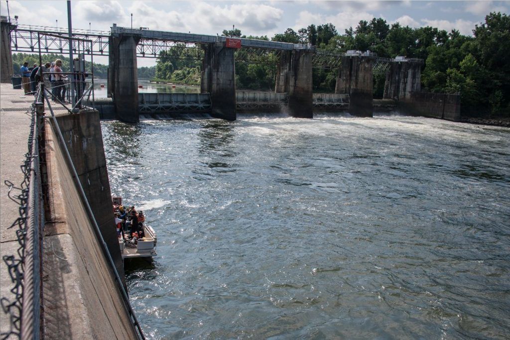 A group of people are riding a boat down a river.