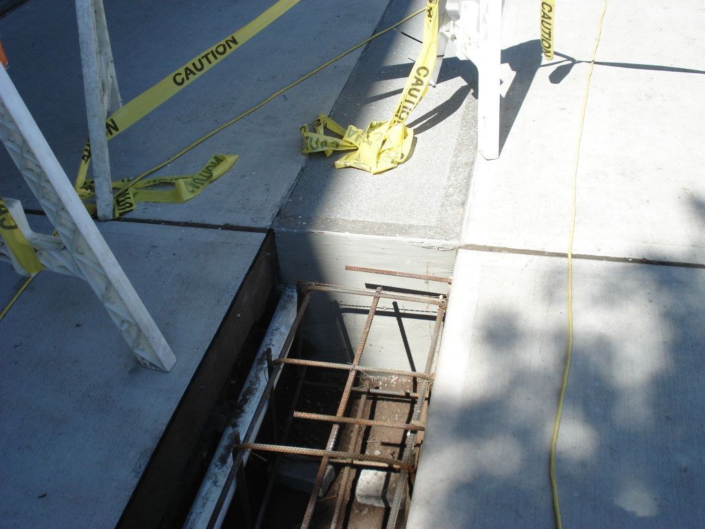 A yellow caution tape is laying on the ground