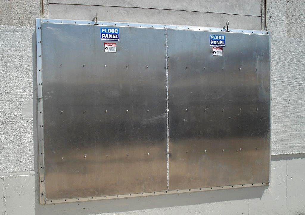 A stainless steel wall with warning signs on it