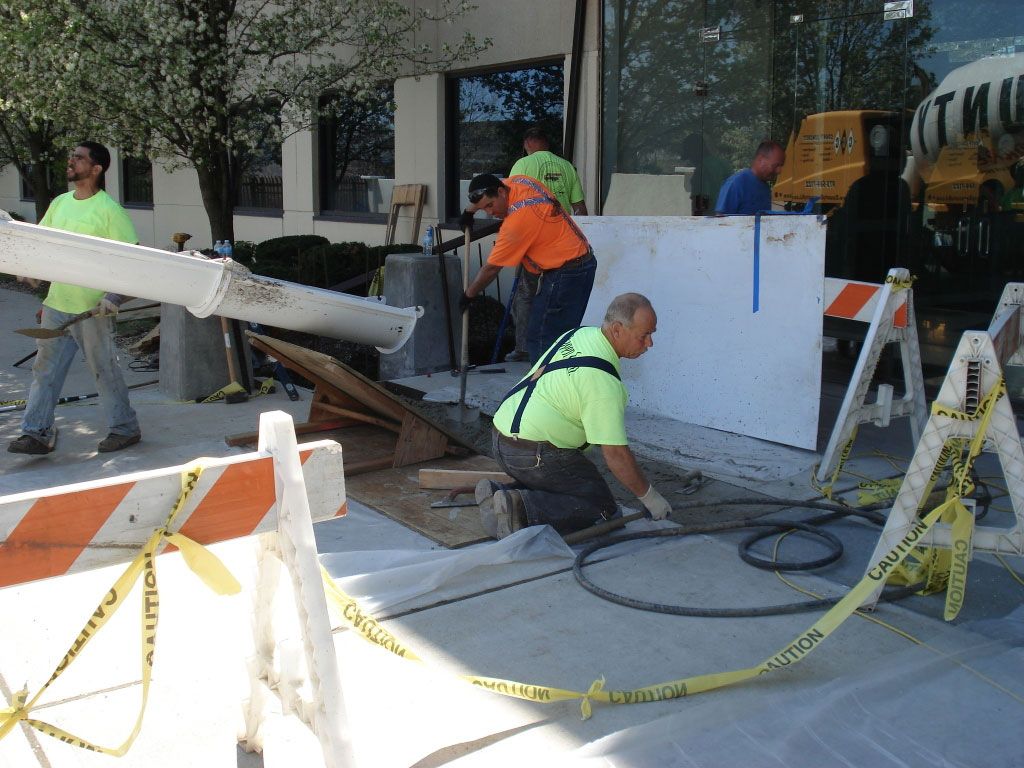 A group of construction workers are working in front of a building