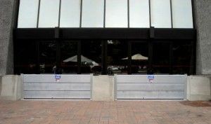 There are two flood barriers in front of a building.